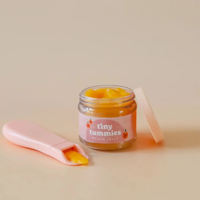 Magisches Glas Tiny Tummies mit Löffel zum Füttern von Puppen – Pfirsich