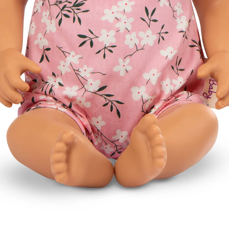 Babypuppe mit Schnuller – In rosa Kleidchen mit Blümchenmuster und Haarband
