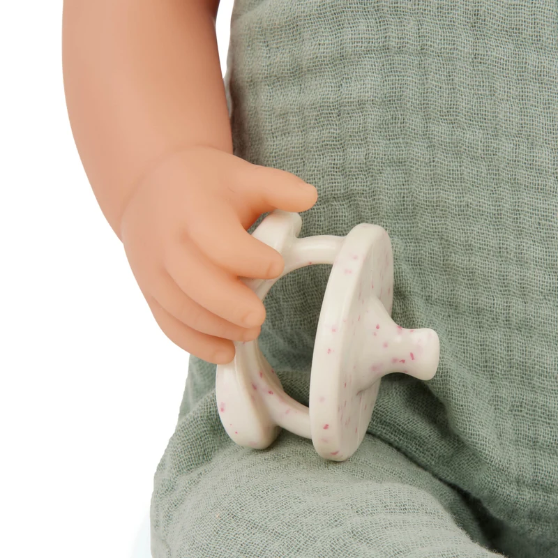 Babypuppe mit Schnuller im Musselinoutfit mit Stirnband